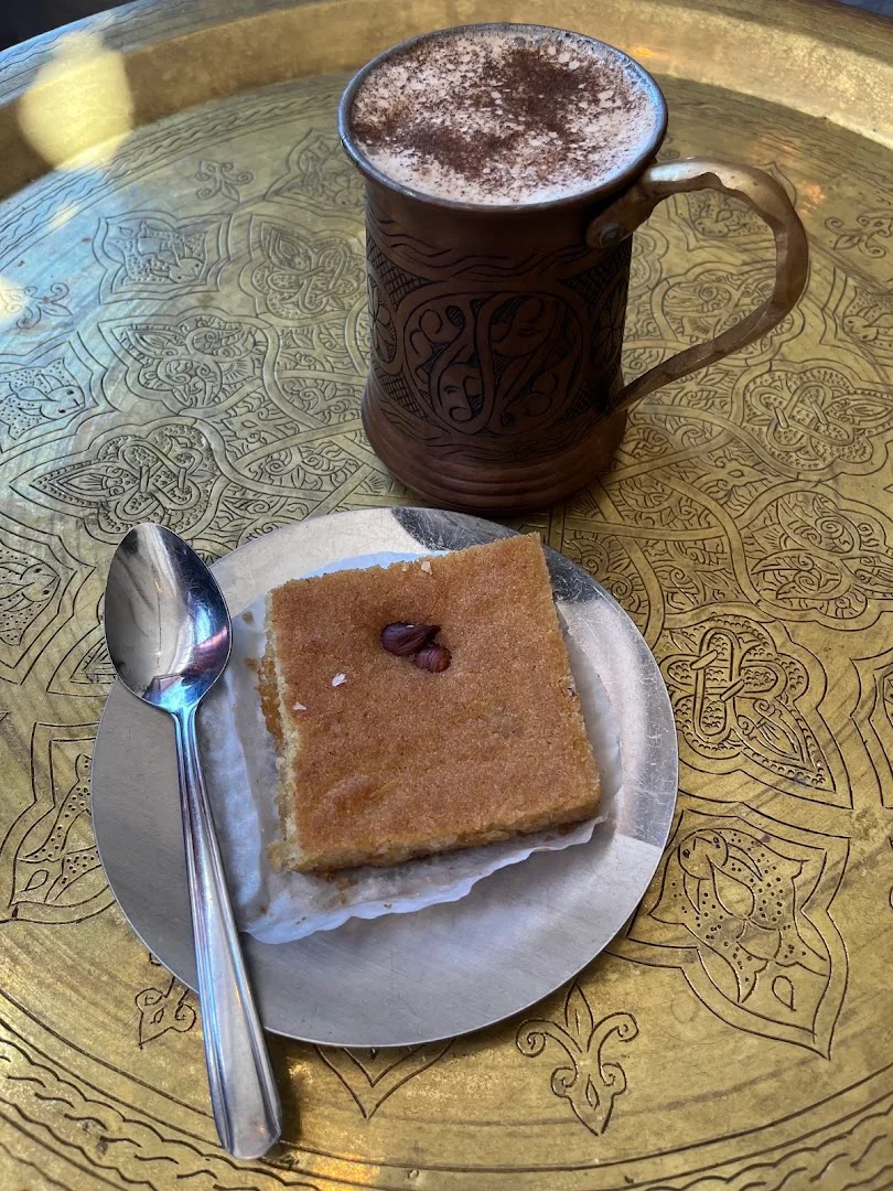 Coffee drink with pastry on decorative yellow geometric table